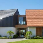 Colorbond vs tile roof Sydney comparison showing modern metal roofing and traditional terracotta tiles on Sydney home