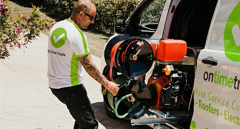Licensed plumber removing tree roots from blocked drain pipes in Sydney